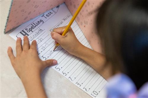 A student takes a spelling test